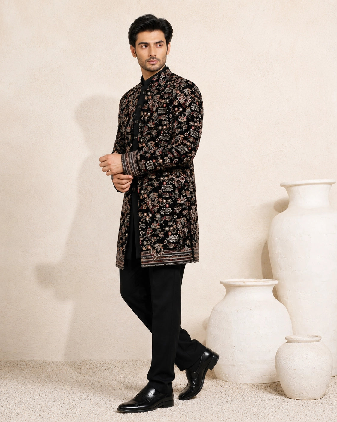 Man wearing a stylish black Indo-Western suit, showcasing modern Indian ethnic wear.