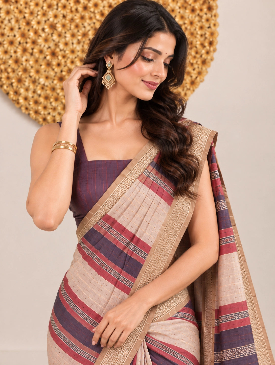 Woman in an elegant blue and pink striped saree with a detailed border.