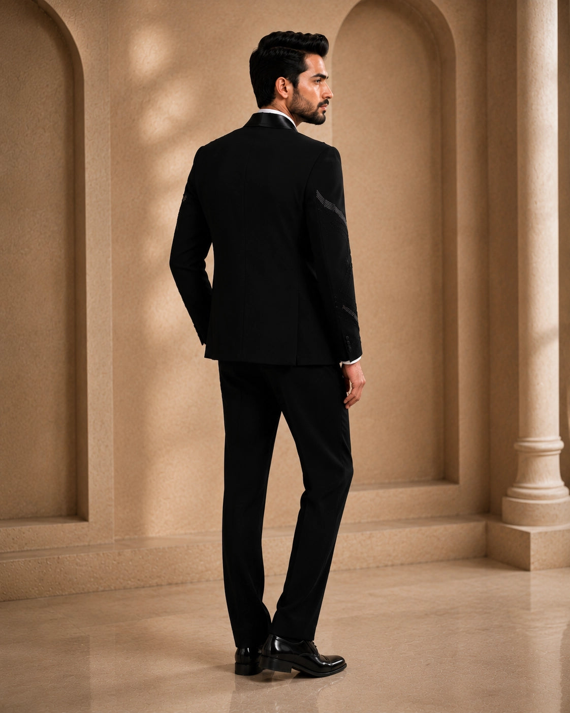 A classic black taxido suit for men, showcasing a sharp silhouette and elegant formal wear.