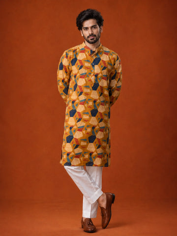 Man wearing a mustard kurta with blue, red, and white geometric print and white pajama.
