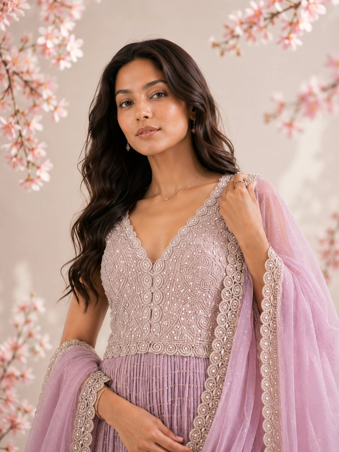 Model in a luxurious pink embroidered Anarkali gown with a flowing dupatta.