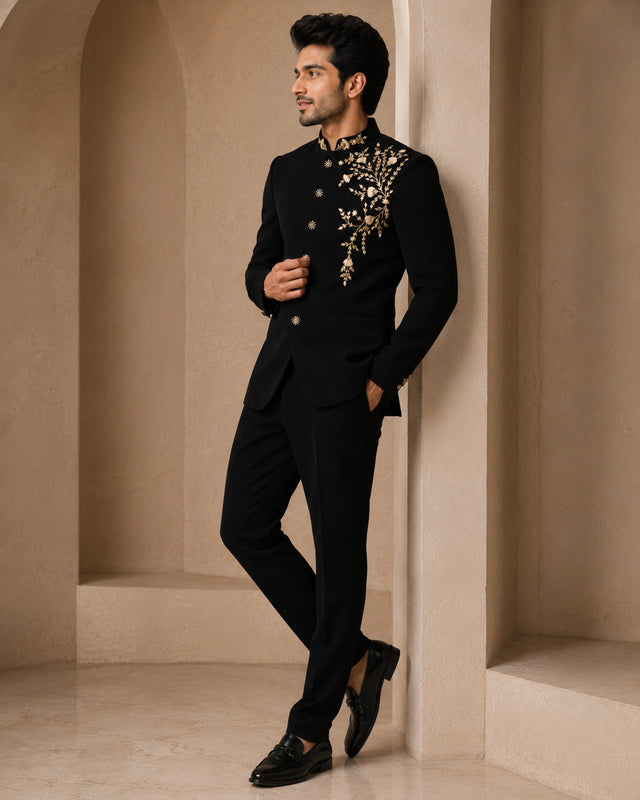 Man wearing a classic black Jodhpuri suit, a traditional Indian formal outfit.