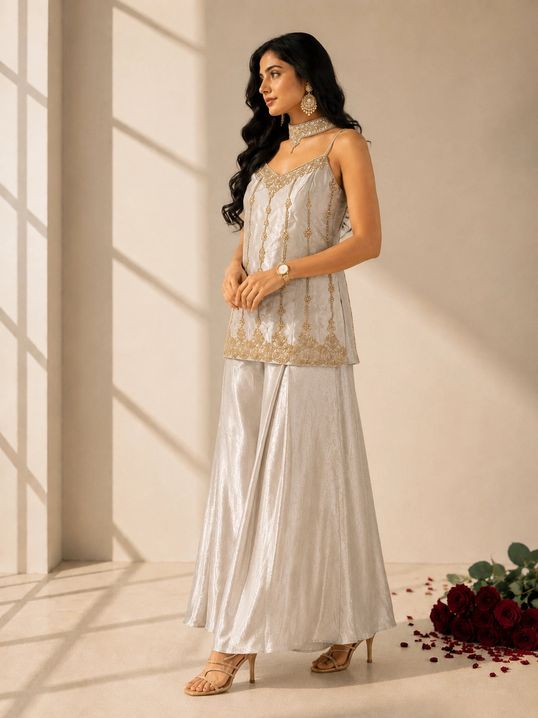 Woman in elegant grey sleeveless kurti with gold embroidery and matching palazzo pants.