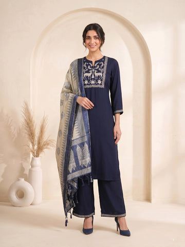 Navy blue embroidered kurti and pants set with a printed dupatta draped over the shoulder.