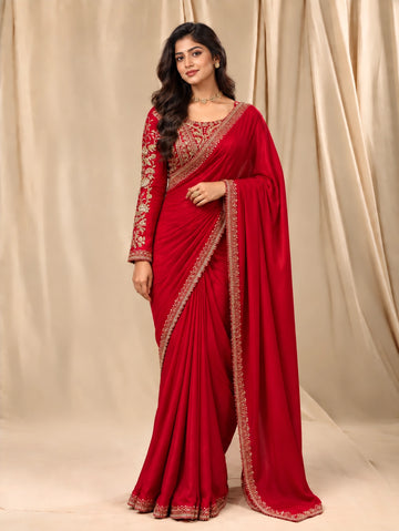Elegant woman in a Rani red  saree with intricate gold embroidered blouse.