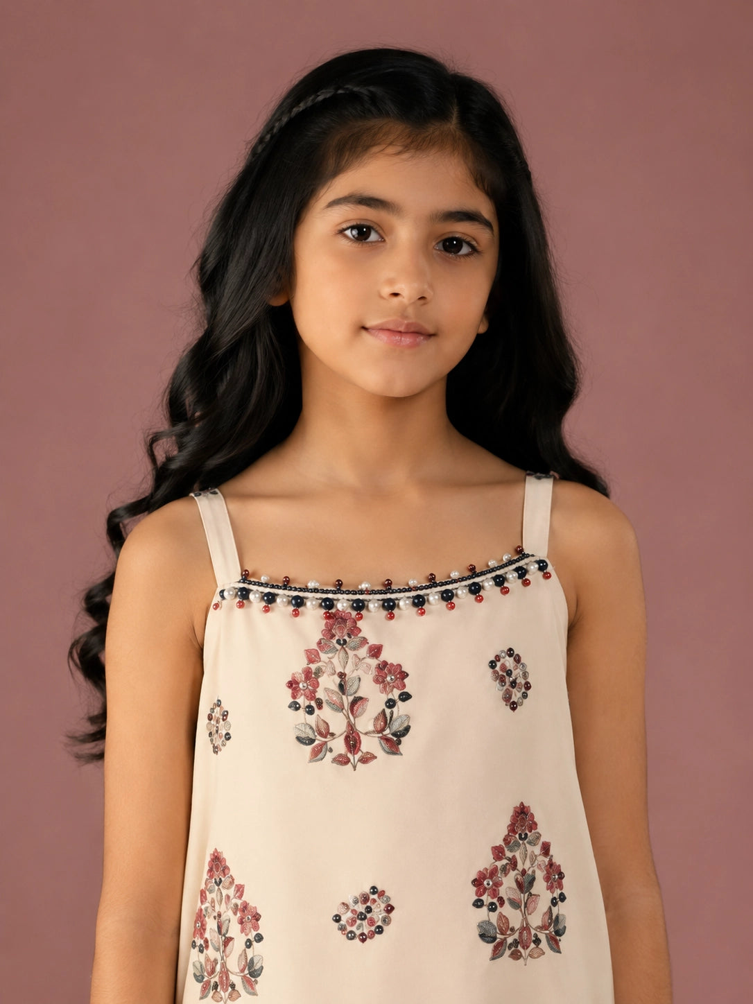 Young girl in a cream floral print strappy top and matching flared sharara set.