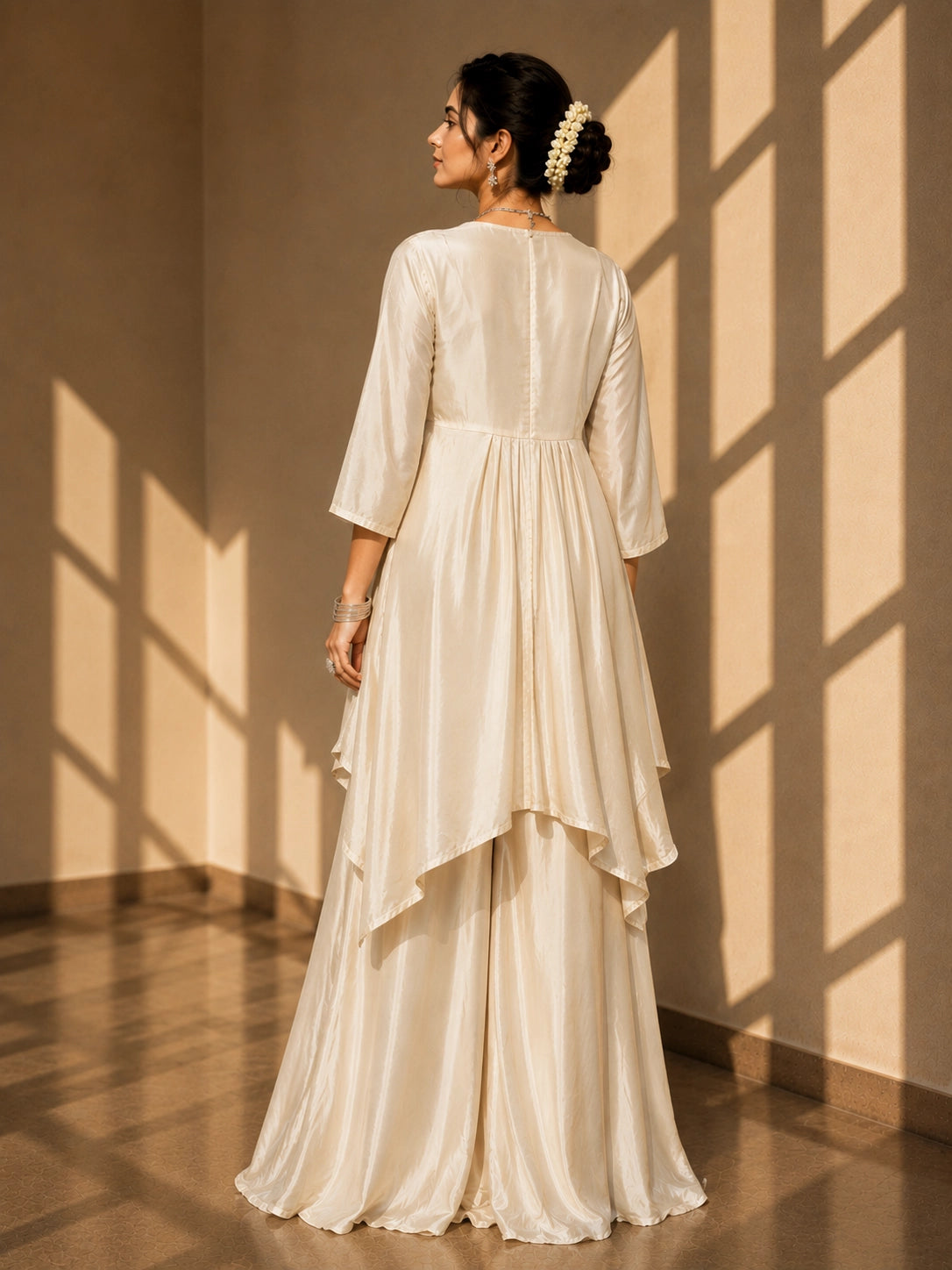 Woman in elegant beige kaftan-style kurti with embellished waist and wide-leg palazzo pants.