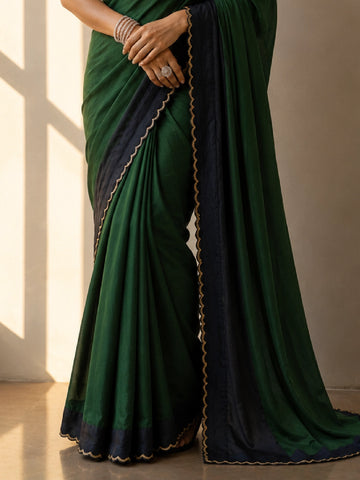 Elegant saree in grey with black scalloped border and gold trim.