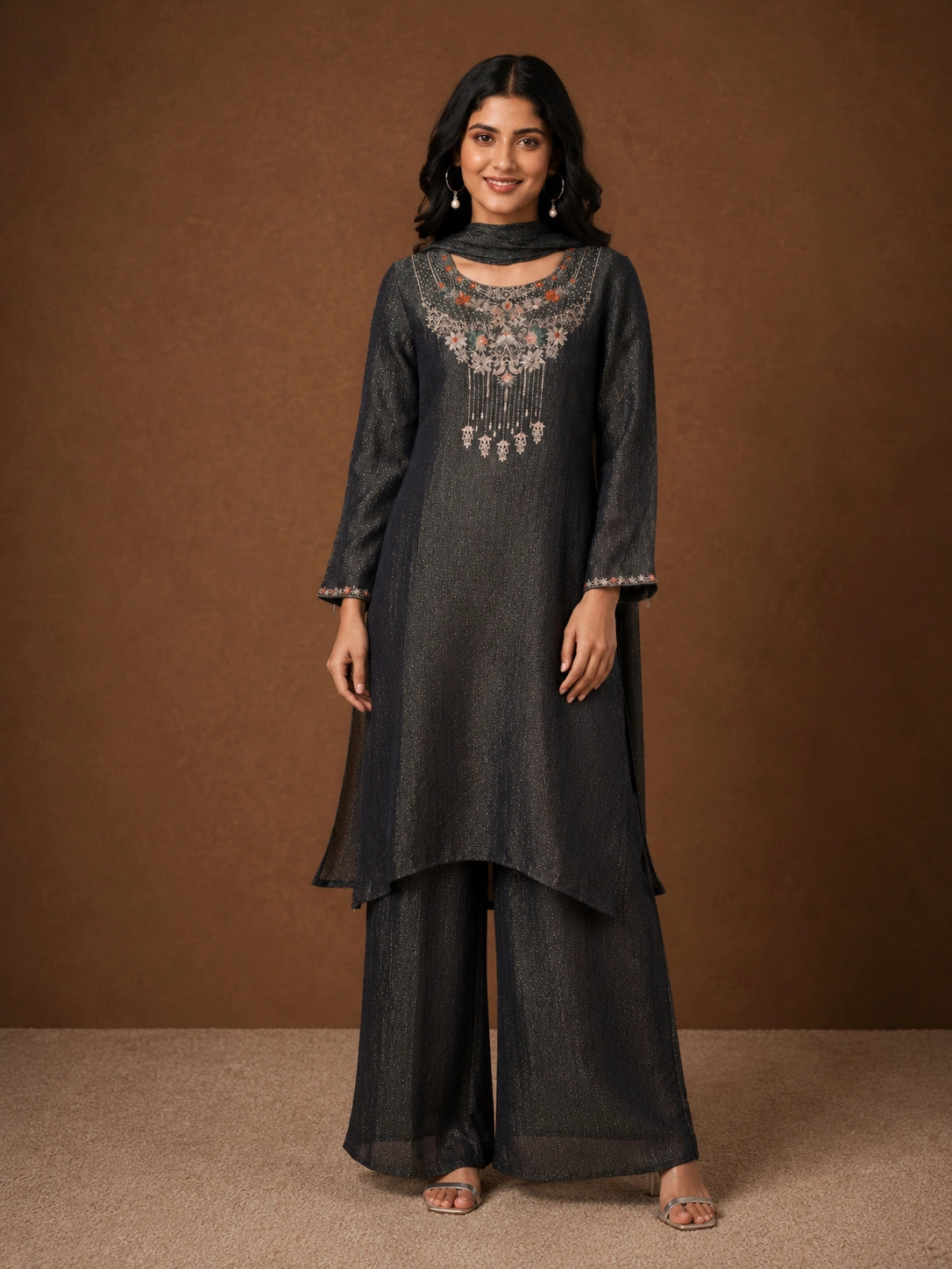 Woman wearing a Fawn sparkling embroidered Sharara with intricate floral details on the neckline and cuffs.
