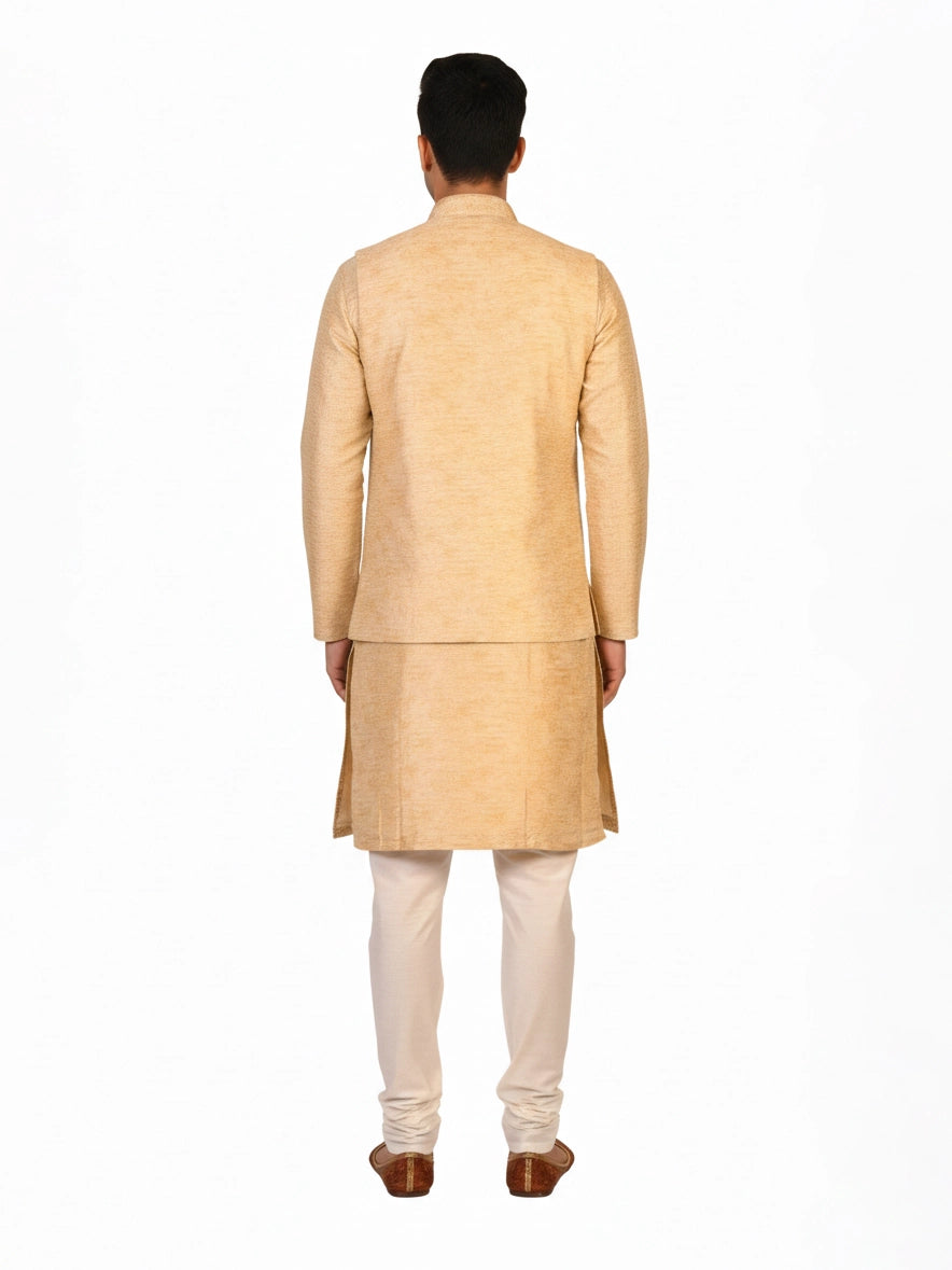 Man wearing a beige embroidered kurta jacket set with golden floral patterns, suitable for festive occasions.