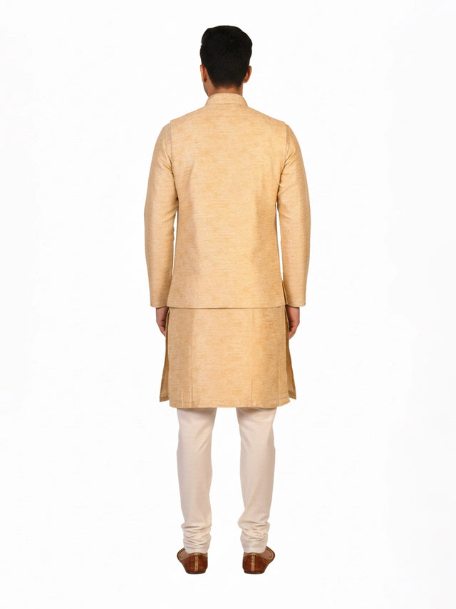 Man wearing a beige embroidered kurta jacket set with golden floral patterns, suitable for festive occasions.