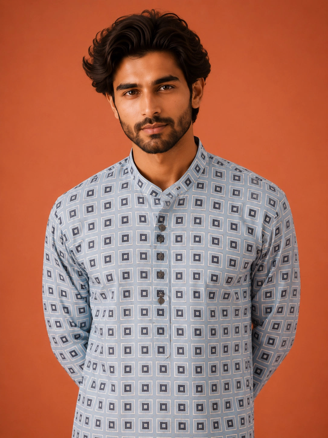 Man wearing sky blue geometric print kurta with white pajama and dark loafers.