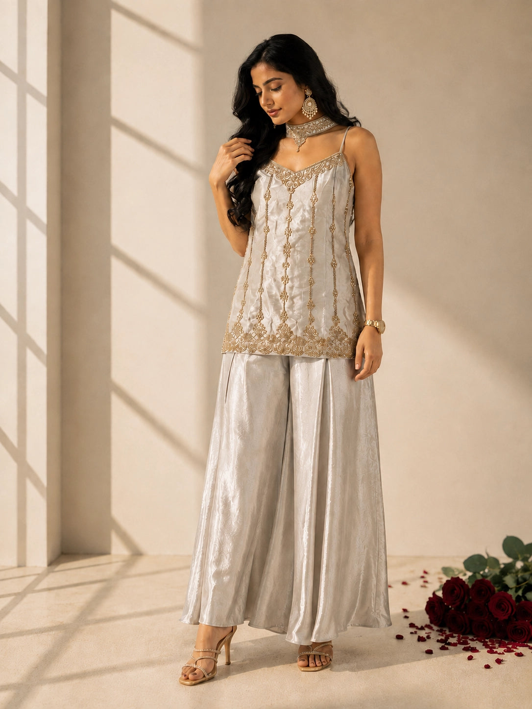 Woman in elegant grey sleeveless kurti with gold embroidery and matching palazzo pants.