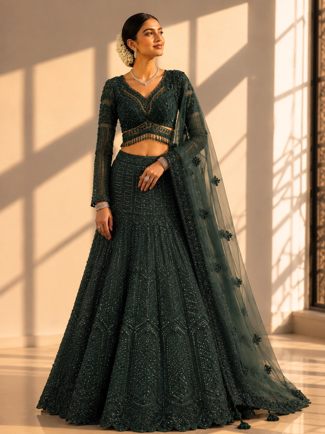 Woman in an exquisite dark green heavily embellished  INDO lehenga choli set.